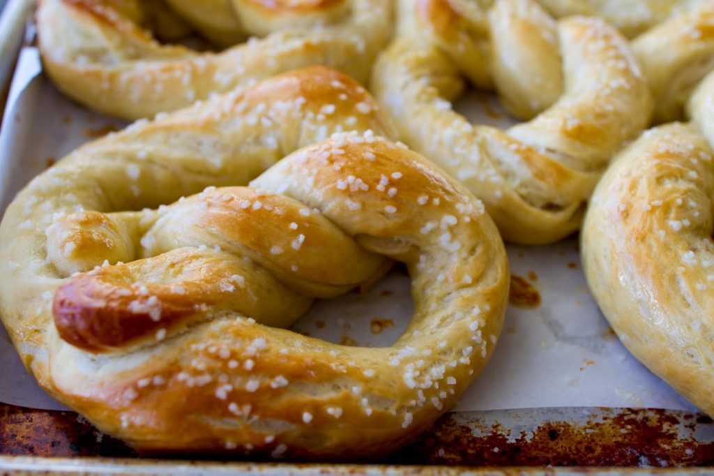 Soft and Chewy Salted Buttered Pretzels on a baking sheet