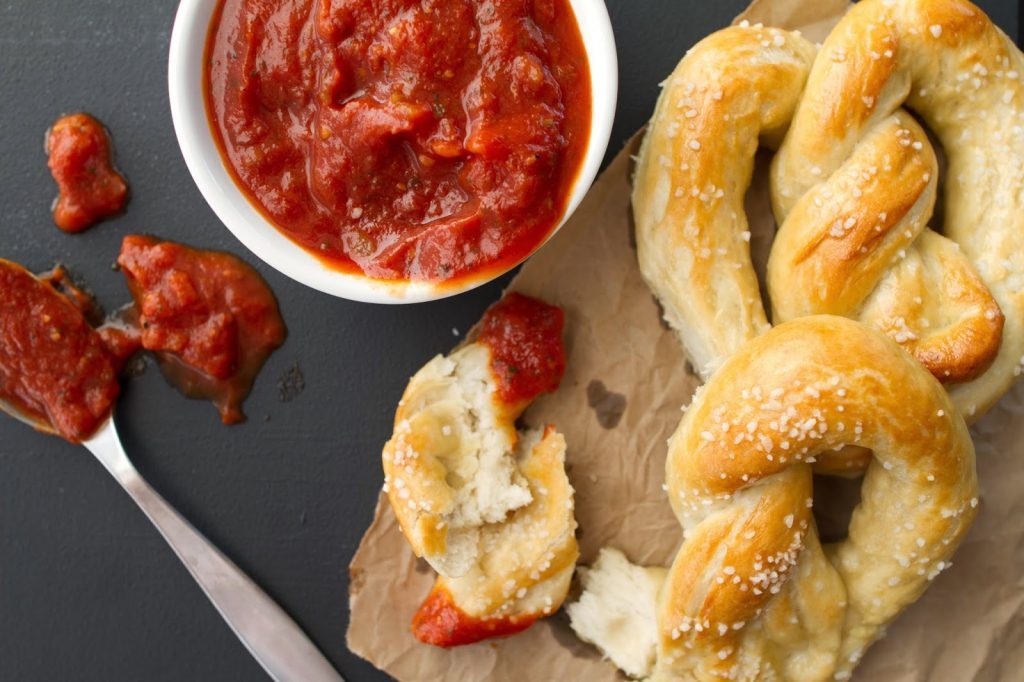 Soft and Chewy Salted Buttered Pretzels with pizza sauce