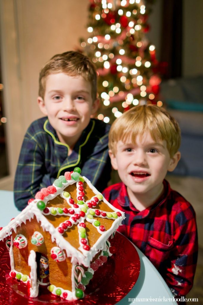 Kids with a gingerbread house for Christmas