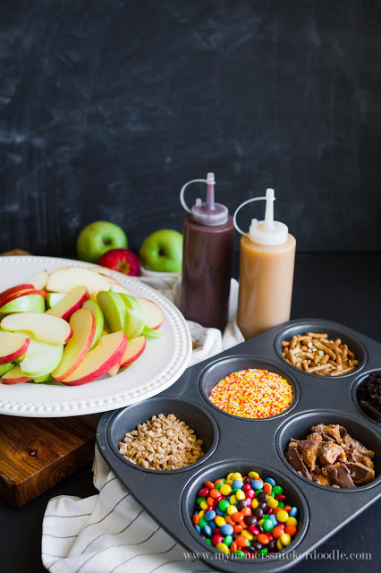 Caramel Apple Nacho Bar with chocolate syrup, candies and pretzels