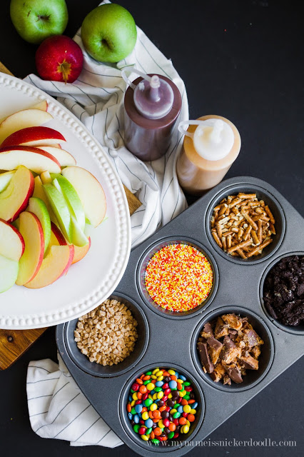 Caramel Apple Nacho Bar with chocolate syrup, toffee, sprinkles, candies and pretzels