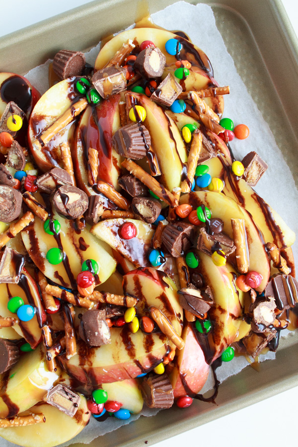 Caramel Apple Nachos fully loaded with caramel sauce, chocolate and candies