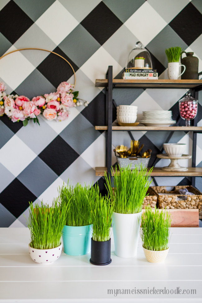 Easter grass in different pots and bowls on a white table