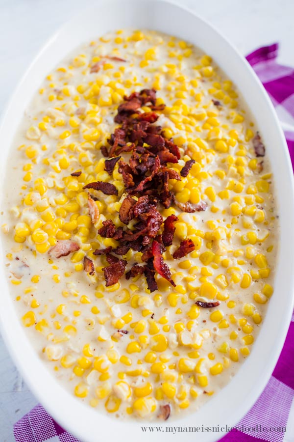 Creamed Corn With crumbled bacon in a white bowl perfect for your holiday feast