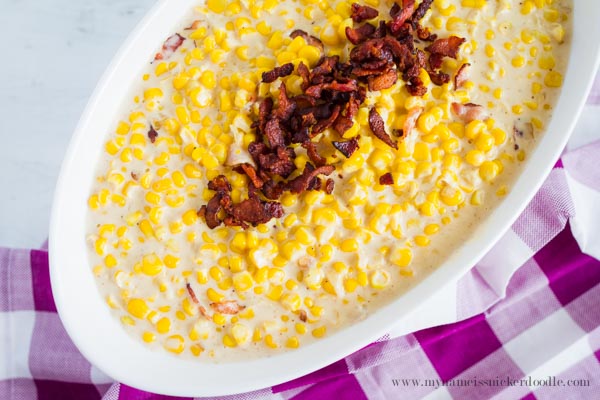 Creamed Corn With crumbled bacon in a white bowl perfect for your holiday feast