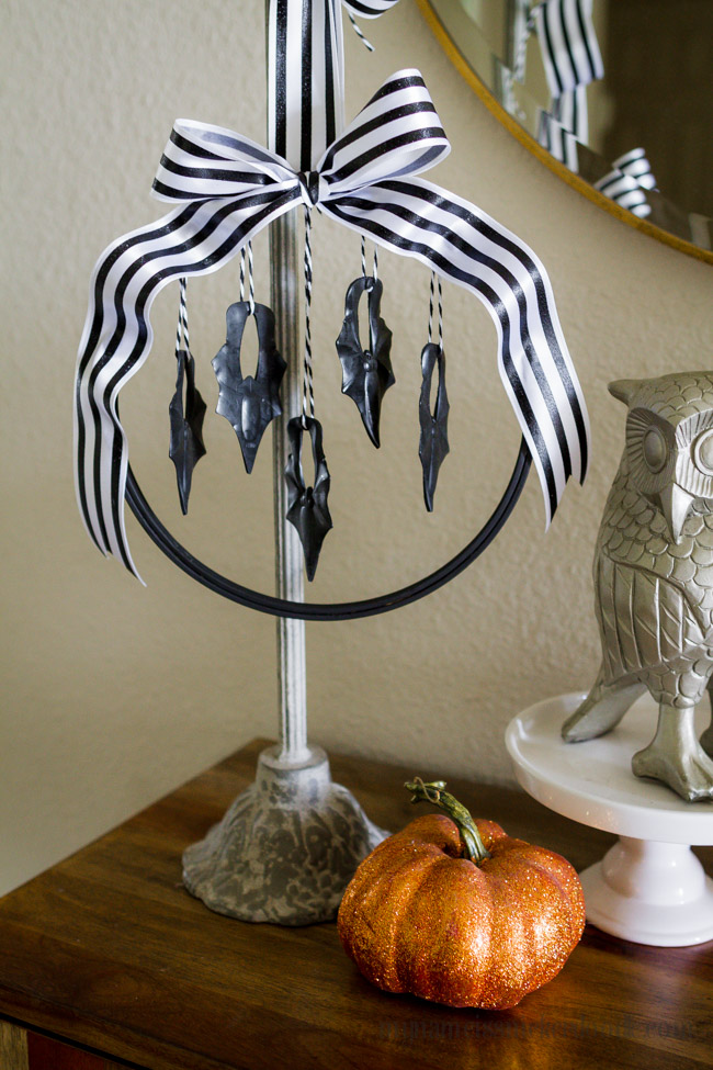 Halloween Hanging Bat Wreath made with an embroidery hoop, cute ribbon and plastic bats