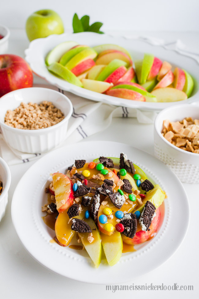 Caramel Apple Nachos with toppings on a white plate