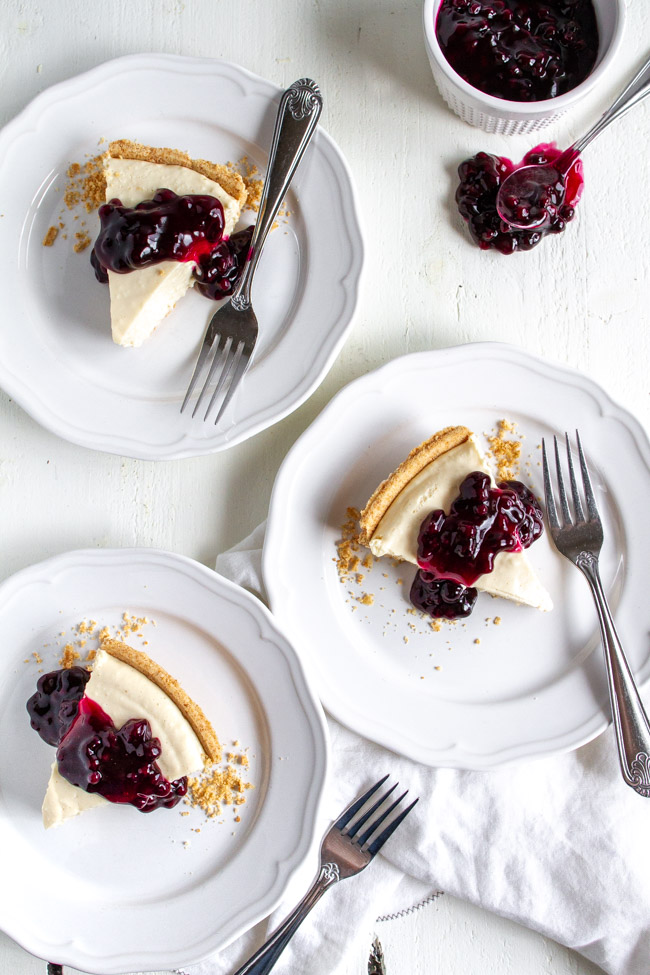 Two slices of no bake cheesecake on a white table.