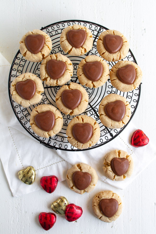 Peanut Butter Blossoms Valentine Version with a chocolate heart on a wire cooling rack