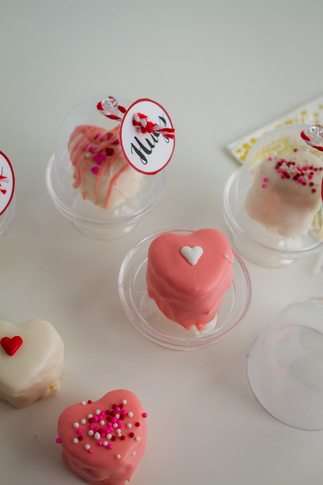 Small pink heart cake on a mini cake stand.