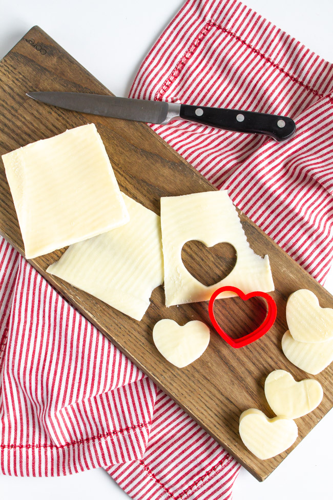 White cheese cut out in hearts with a small cookie cutter.