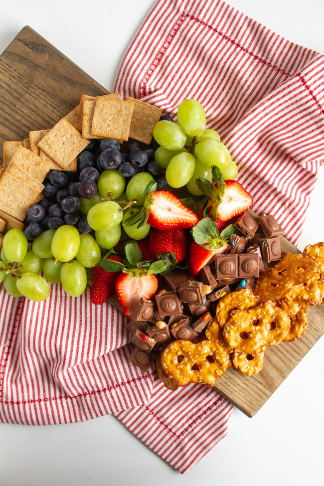 Crackers, fruit and chocolate on a wood board