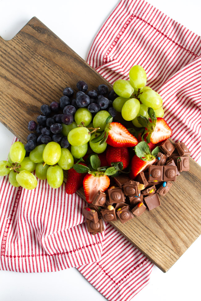 Fruit and chocolate on a wood cutting board