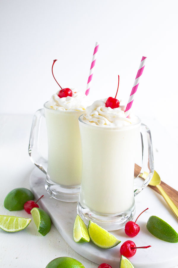 Two glass mugs full of Frozen Key Lime beverage.