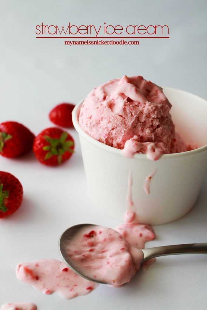 A white bowl full of strawberry ice cream.