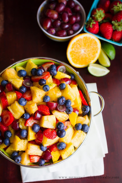 Summer Fruit Salad in a bowl on a brown table.