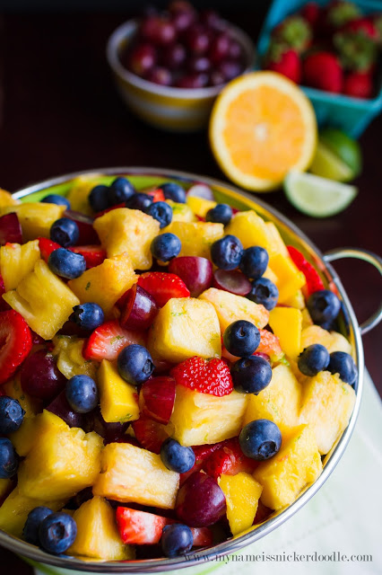 Pineapple fruit salad in a bowl on a dark table.