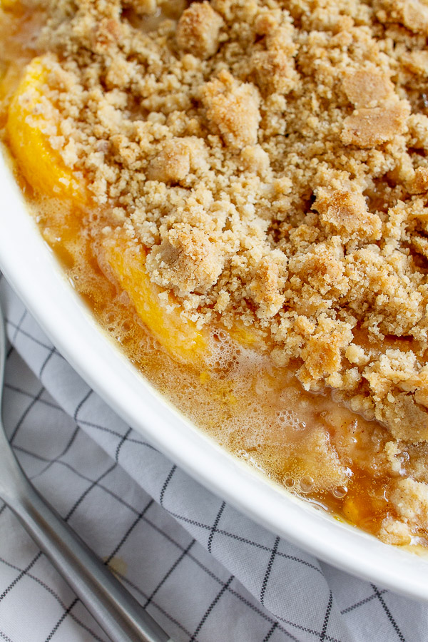 Bubbling sweet peaches topped with a buttery golden brown crumble.