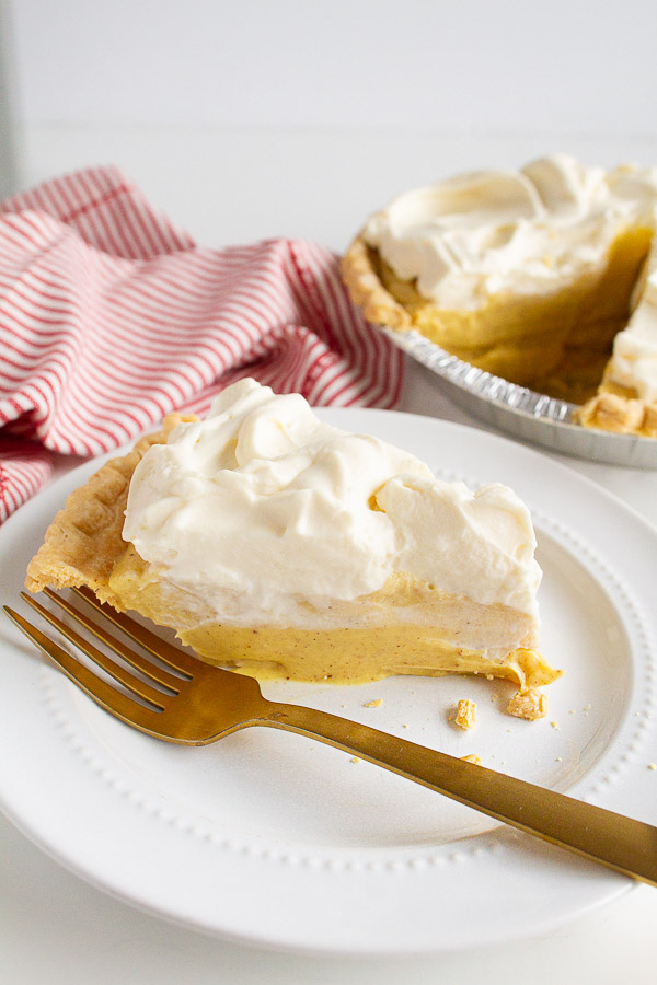 Holiday Eggnog Pie is a super simple recipe with a slice on a white plate.  