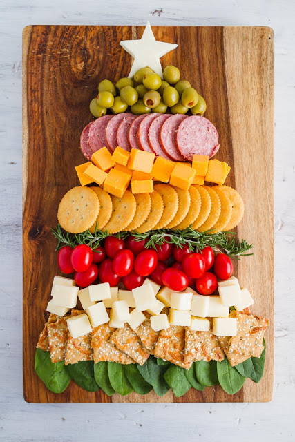 The Ultimate Holiday Appetizer! A Christmas Tree Cheese and Cracker Tray would be great for any holiday party. Full of meats, cheeses, crackers and vegetables. The easiest charcuterie board to assemble! #charcuterie #holidayappetizer #mynameissnickerdoodle #cheeseandcrackers #partyfood #christmasappetizers #easyappetizers #appetizerrecipes #christmasrecipes