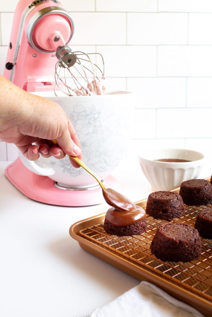 Chocolate ganache spooned over the best little mini chocolate cakes!