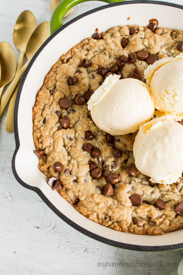 Chocolate Chip Skillet Cookie is fresh from the oven and topped with a few scoops of ice cream!  