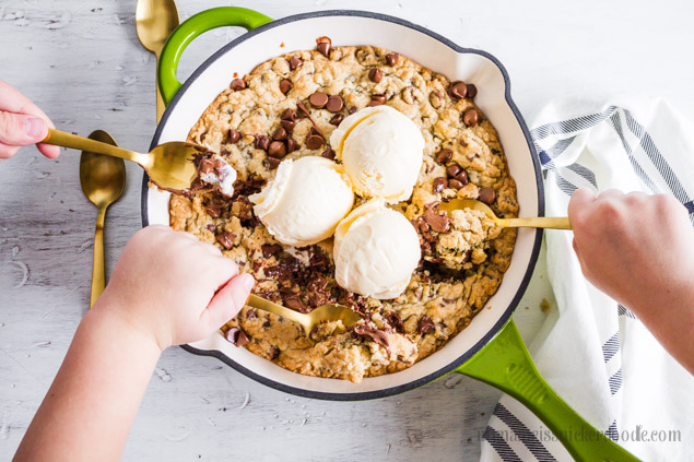 Chocolate Chip Skillet Cookie is served warm with a few scoops of ice cream on top to finish it off!  