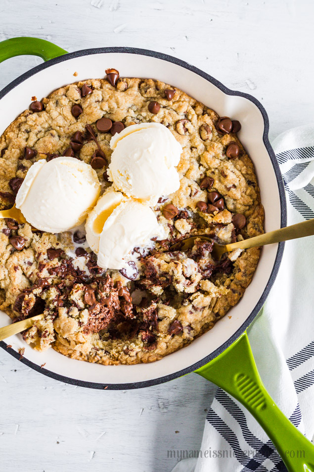 Chocolate Chip Skillet Cookie is served warm with a few scoops of ice cream on top to finish it off!  