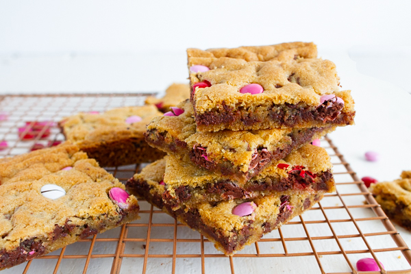 Valentine Chocolate Chip Cookie Bars with pink and red candies.