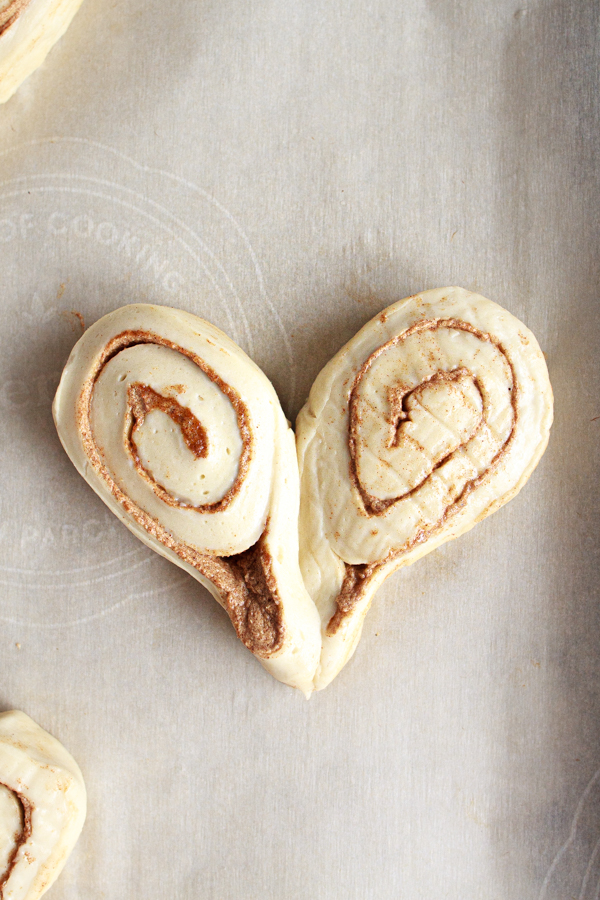 Form two cinnamon rolls together to make a heart shape breakfast pastry.