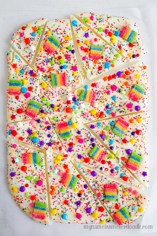 White Chocolate candy bark with rainbow sprinkles and gummies.