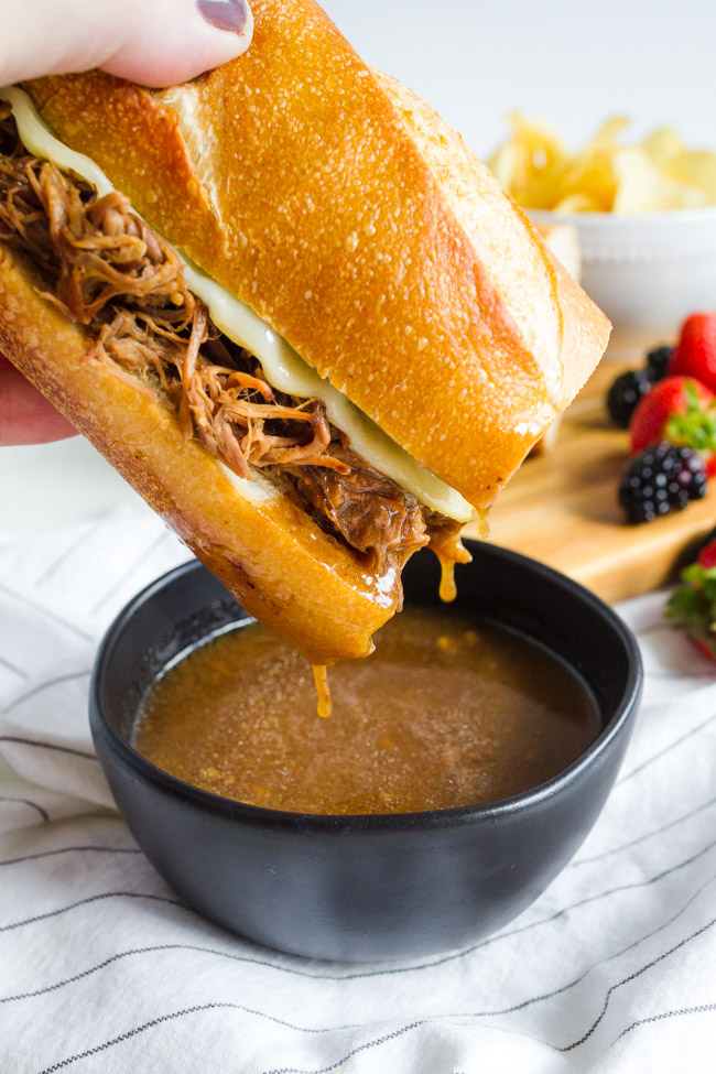 Slow cooker French Dip Sandwiches dipped in Au Jus.