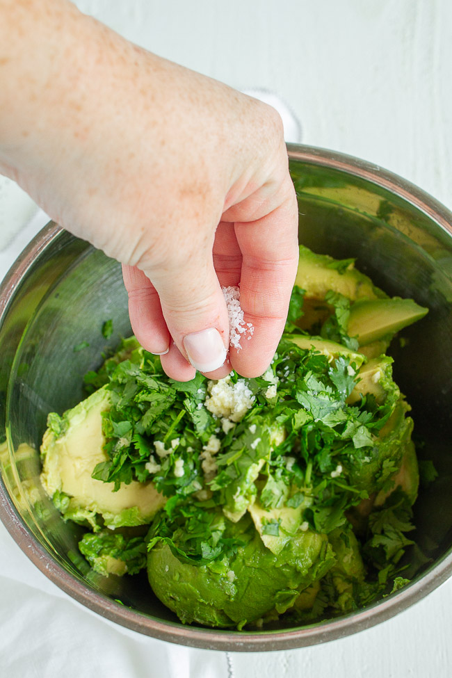 Kosher salt sprinkled over fresh avocados.