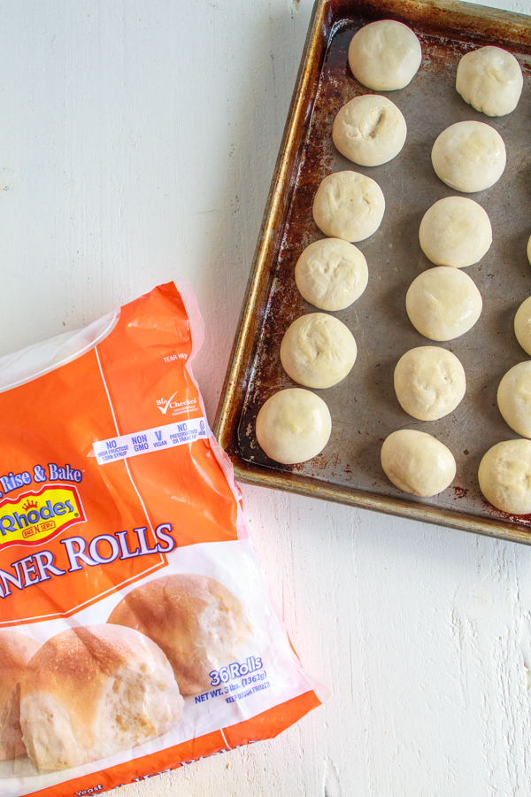 Frozen rolls on a baking sheet.