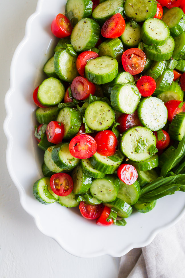 Tomato cucumber salad on a white dish.