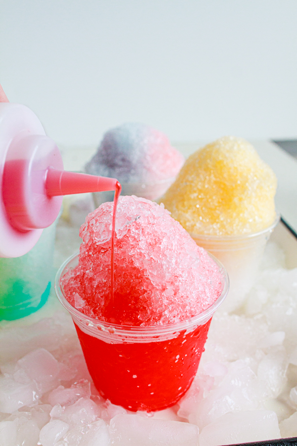 Tiger's Blood syrup being poured over shaved ice.  