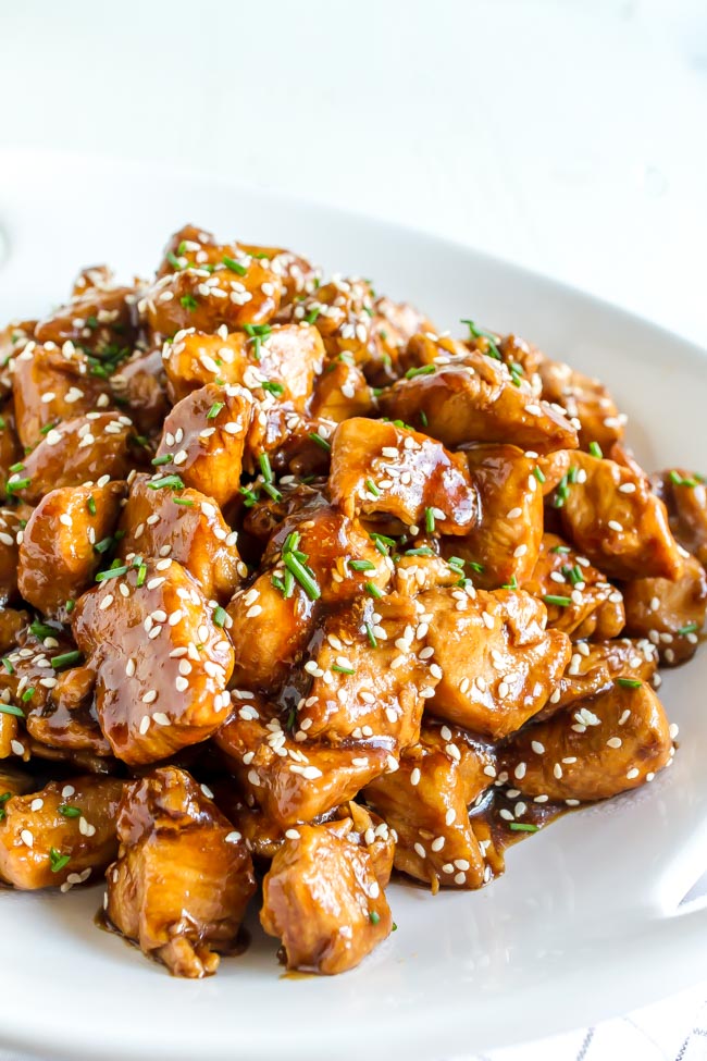 Sesame Chicken sprinkled with sesame seeds and chopped chives.