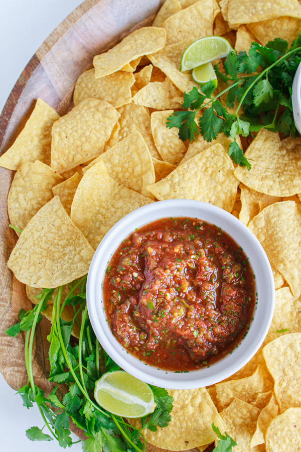 Mild easy salsa on a platter with tortilla chips.