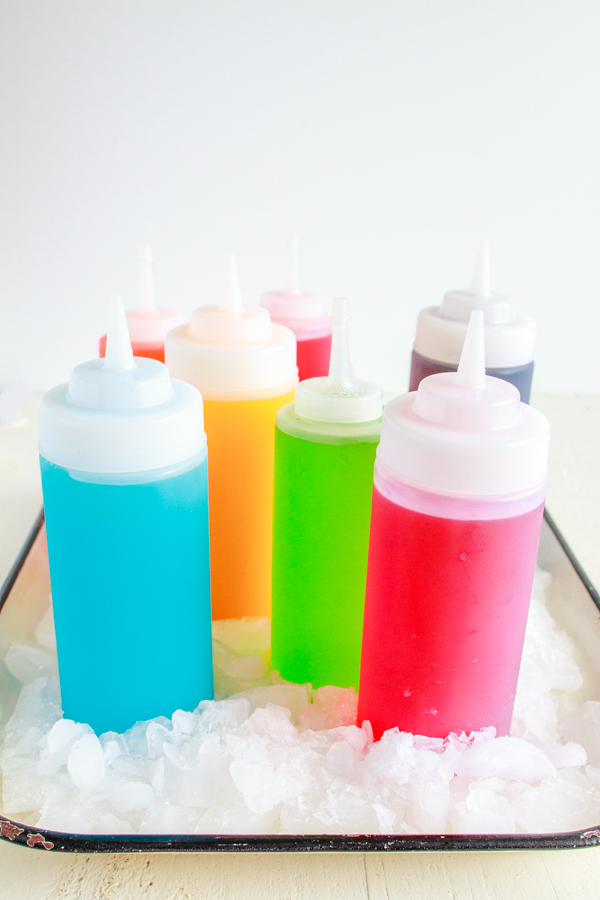 Homemade Sno Cone Syrup in white plastic bottles.