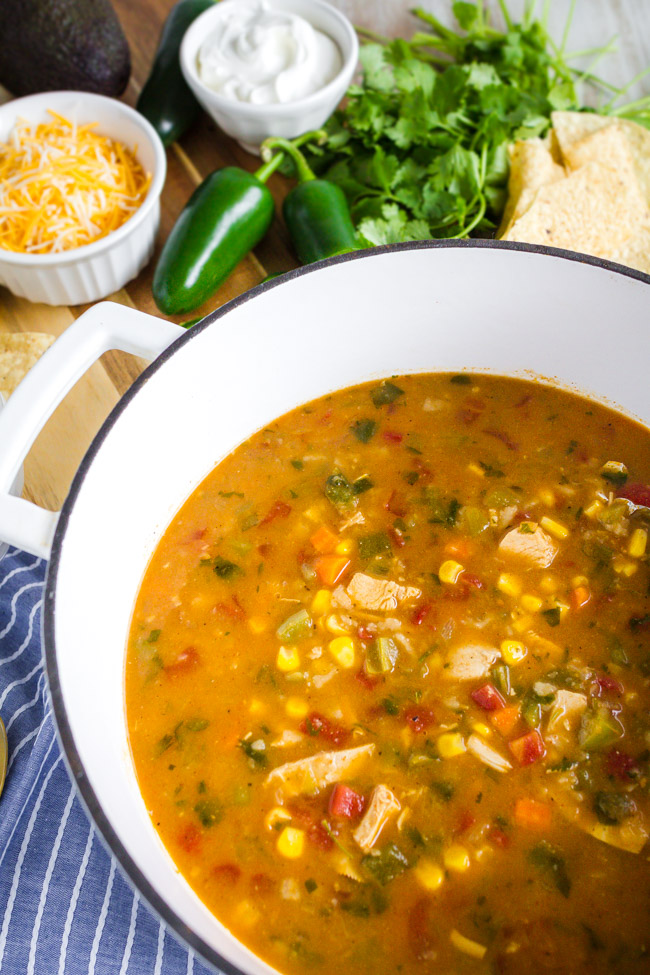 A large white pot full of Chicken Tortilla Soup.