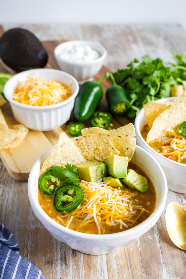 Chicken Tortilla Soup garnished with jalapenos and avocados