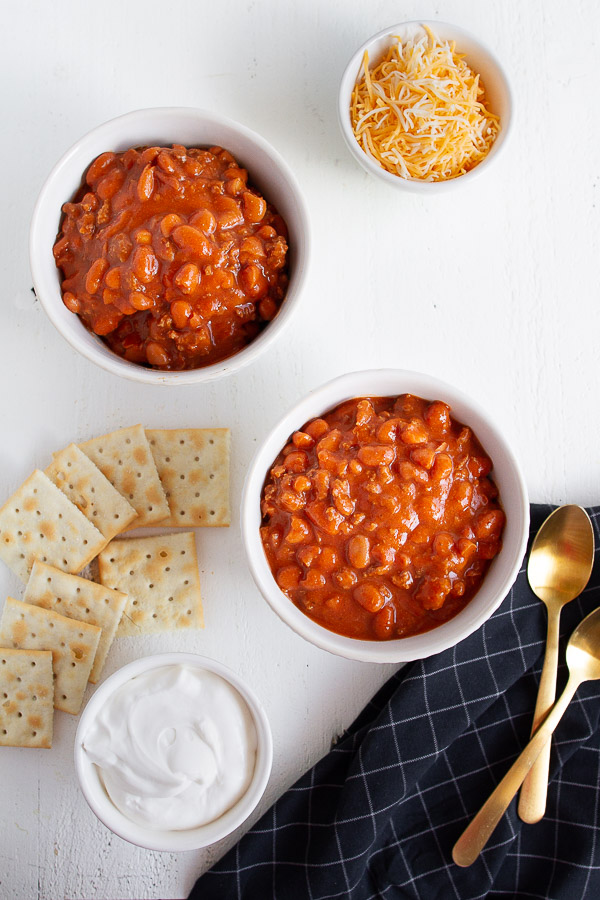 Two white bowls full of chili.