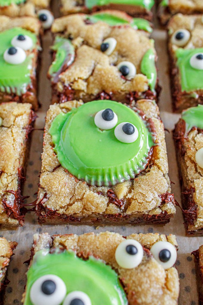 Spooky chocolate chip cookie bars with googley eyes and green peanut butter cups.