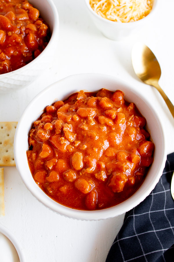 A white bowl full of chili.