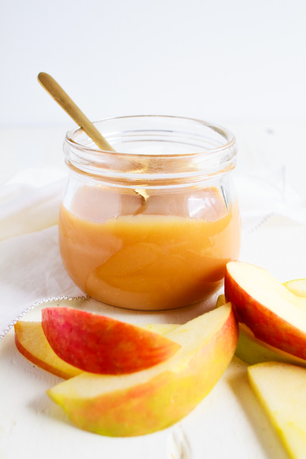 A clear jar full of homemade caramel sauce