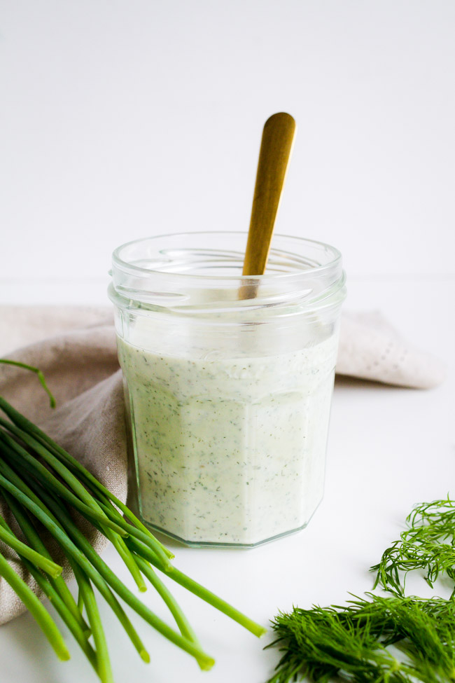 A jar of full of Homemade Ranch Herb Dressing