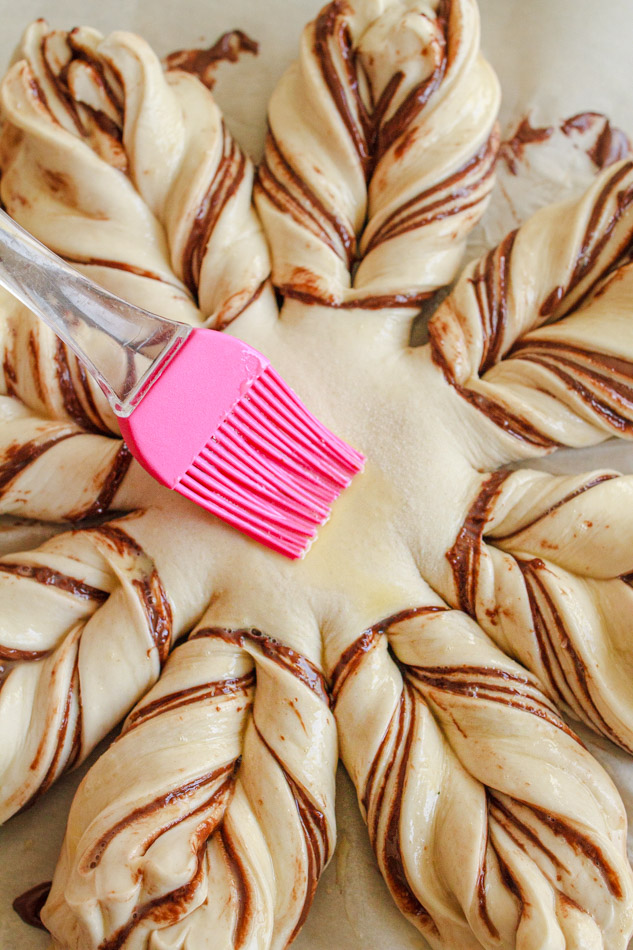 Star Bread being brushed with egg wash.