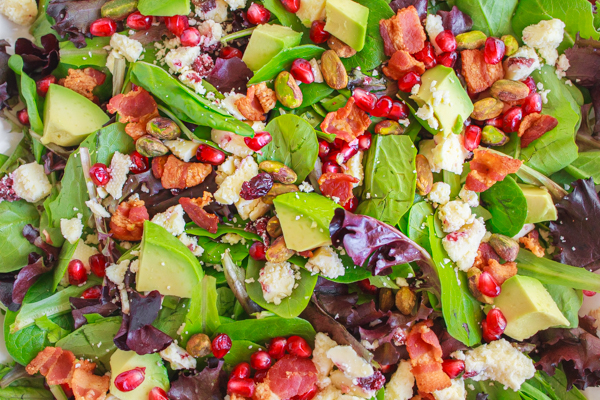 Holiday recipe for Pomegranate Avocado Salad with bacon, pistachios and wensleydale cheese.