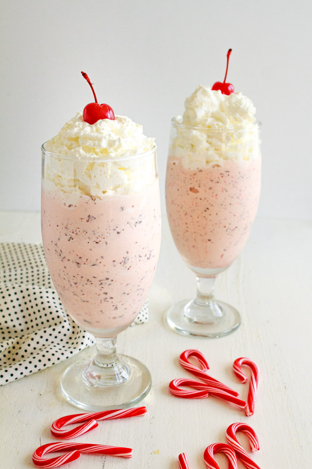 Two Peppermint Chip Milkshakes with whipped cream and a cherry on top.