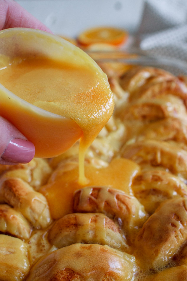 Easy Orange Sweet Rolls are just as easy as boiling water.  Yes, these are semi-homemade so you don't have to worry if you don't know how to make bread from scratch.  It's the extra steps of adding cream, brown sugar and orange zest to the bottom of the pan that creates these ooey-gooey Orange Rolls.  